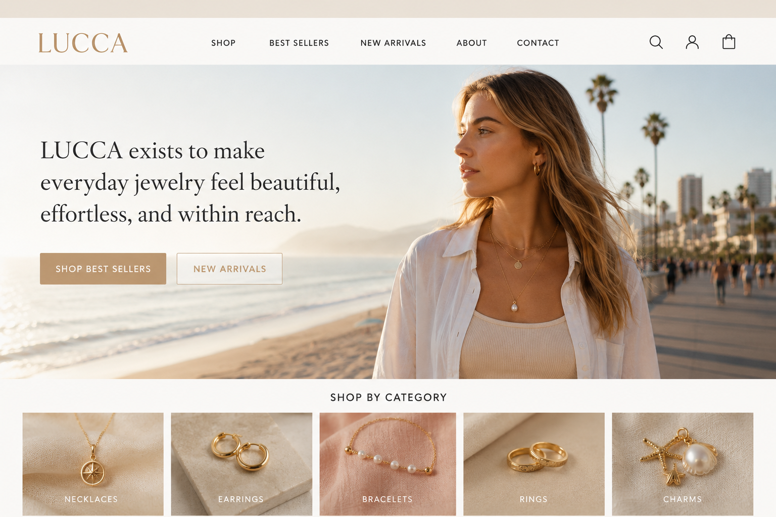 Woman wearing layered gold jewelry on a Los Angeles beach